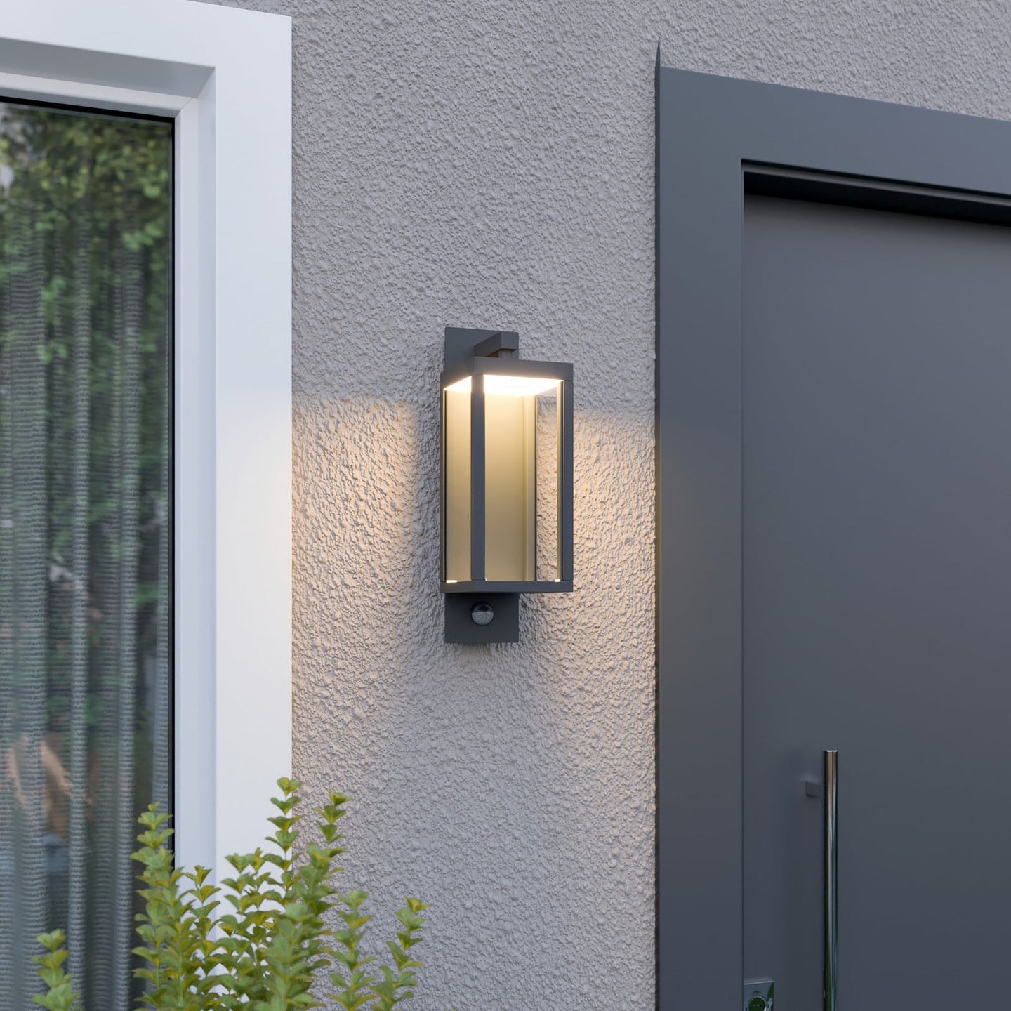 Denro outdoor wall light glowing warm white next to a house entrance and window