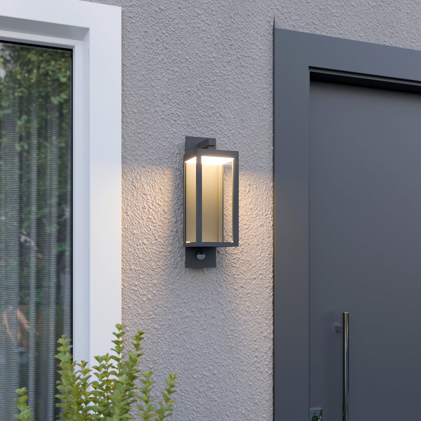 Denro outdoor wall light glowing warm white next to a house entrance and window