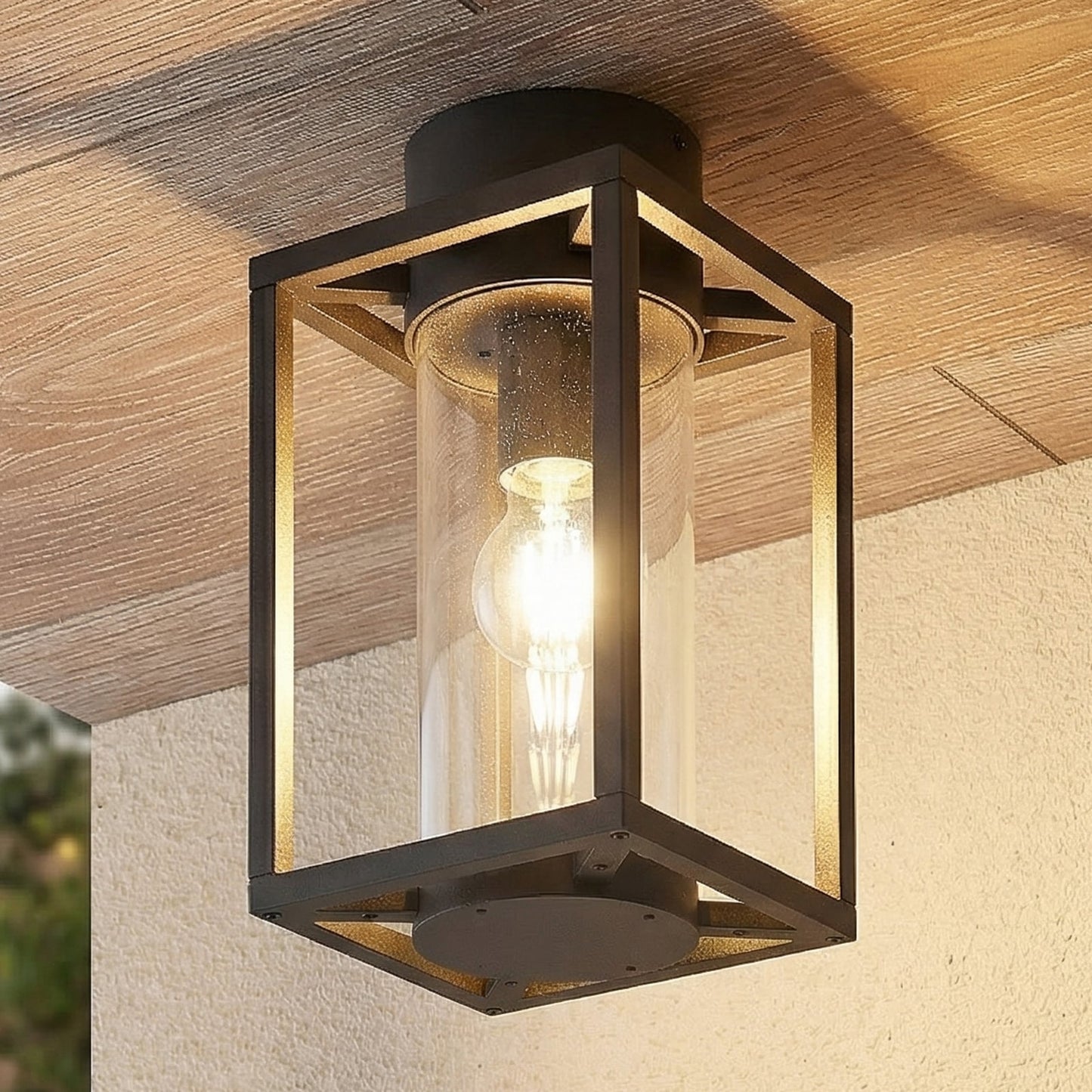 Vesa ceiling light fitted to a timber porch ceiling above a rendered wall at dusk