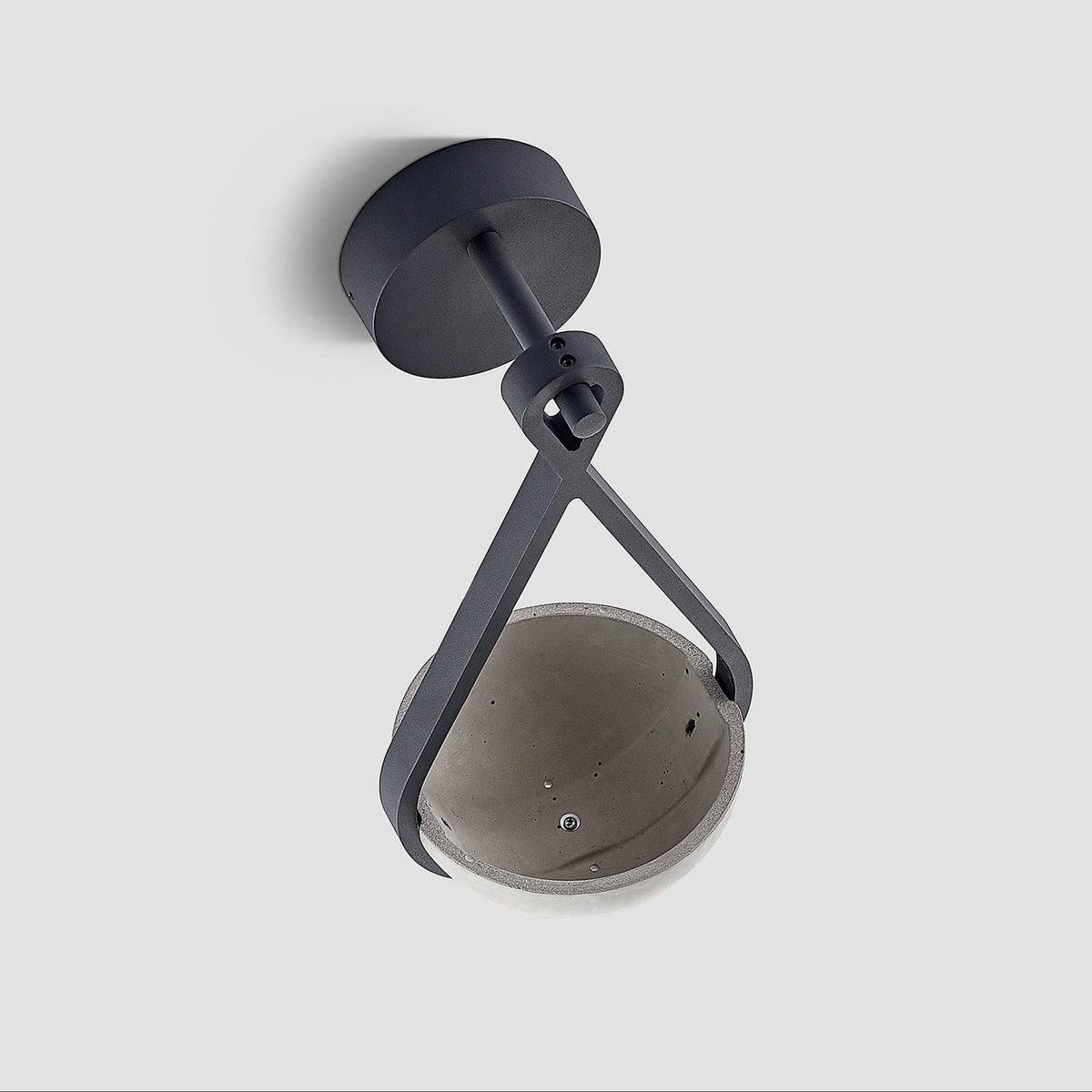 Angled view of the Norva Stone Planter Outdoor Wall Light showing the inside of the concrete planter bowl