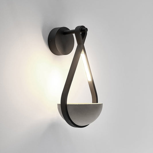 Norva Stone Planter Outdoor Wall Light on a plain background with the LED lit above the concrete bowl