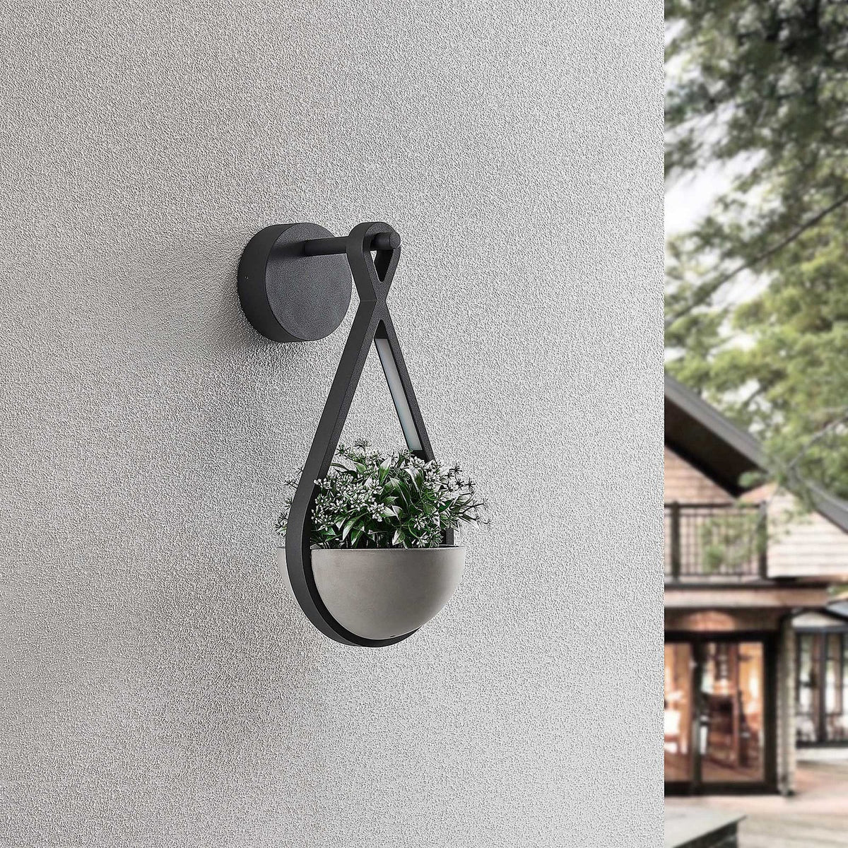 Norva Stone Planter Outdoor Wall Light fitted to an exterior wall with a small plant in the bowl