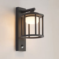 Berno outdoor wall light switched on against a plain warm grey wall showing the downward glow