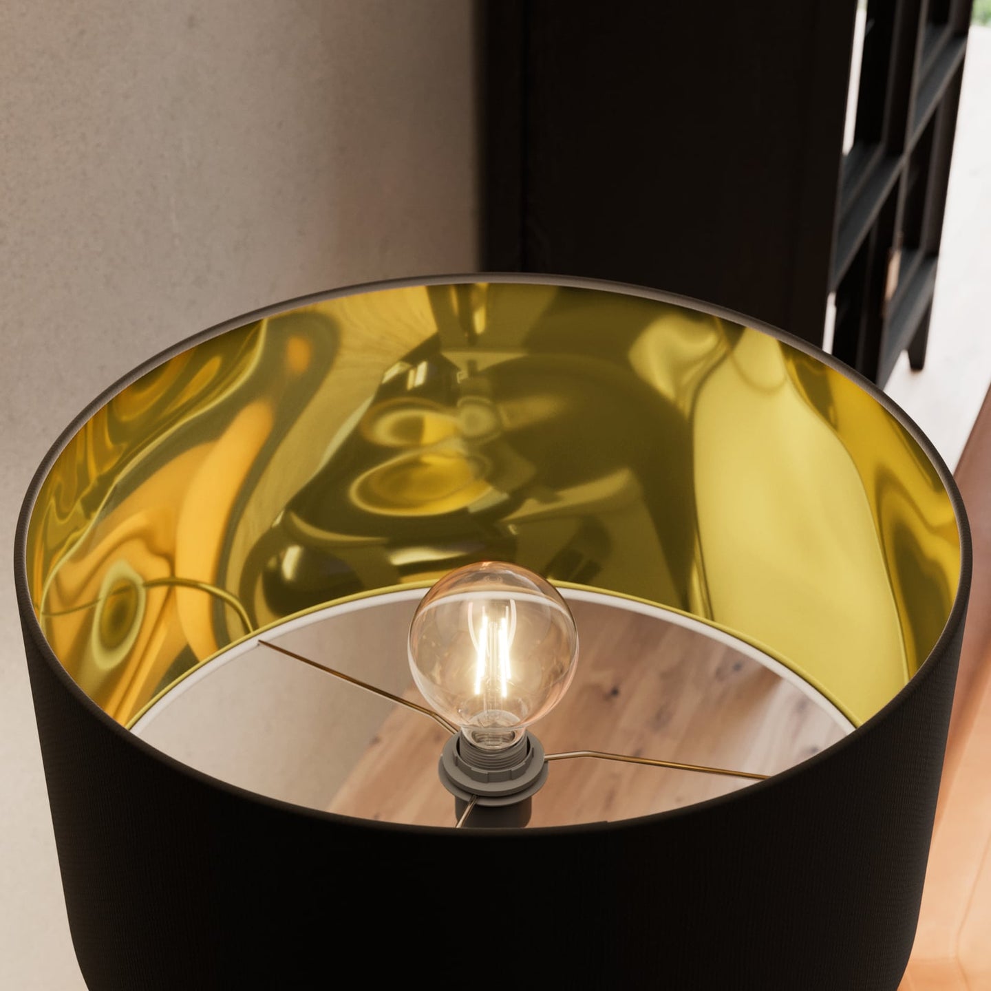 Looking up into the Beno floor lamp shade showing the reflective gold interior lining and the lit bulb