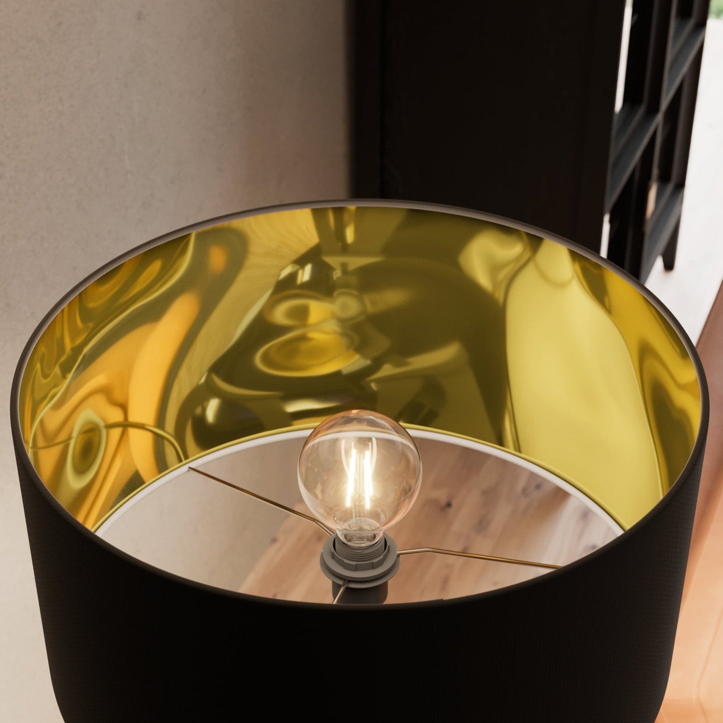 Looking up into the Beno floor lamp shade showing the reflective gold interior lining and the lit bulb