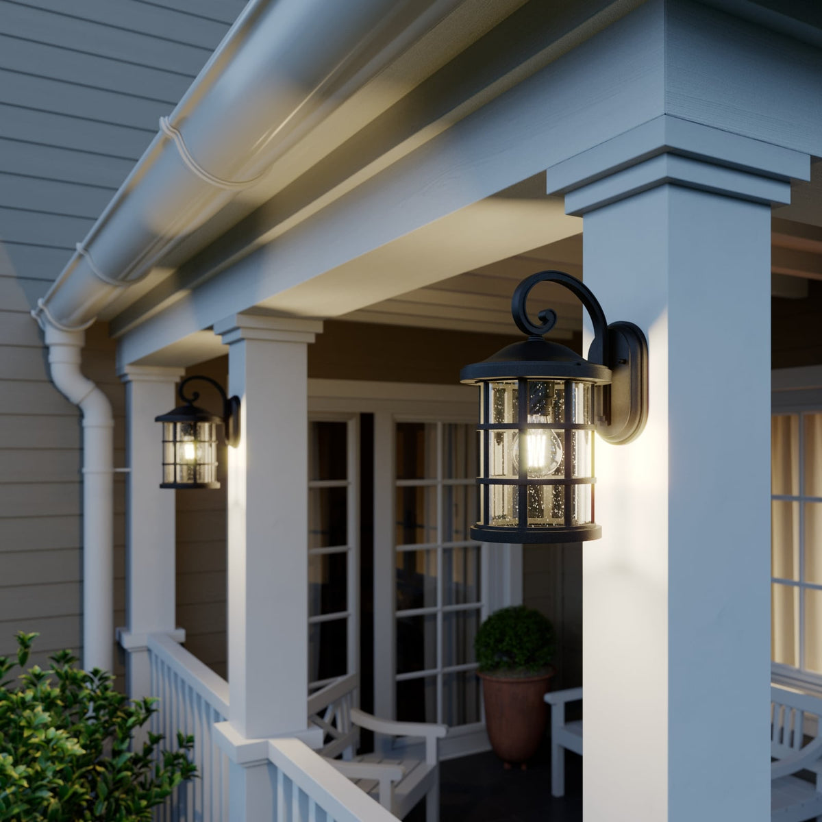Two Ankor lanterns lighting a covered porch with white railings and a seating area
