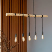 Rovo pendant light seen at an angle against a slatted wood wall, five amber filament bulbs glowing