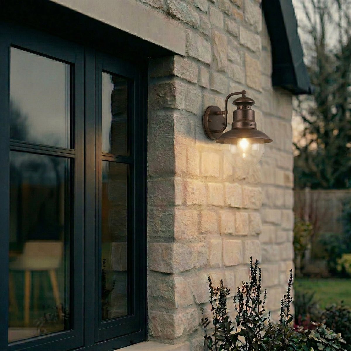 Erdo Rust Lantern Outdoor Wall Light mounted on stonework beside a dark window frame