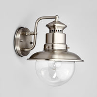 Three quarter view of the Gwena outdoor wall light showing the curved steel wall arm and round backplate