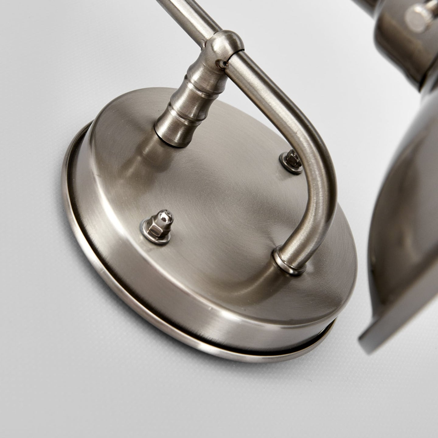 Close-up of the Gwena wall light stainless steel backplate and fixing detail