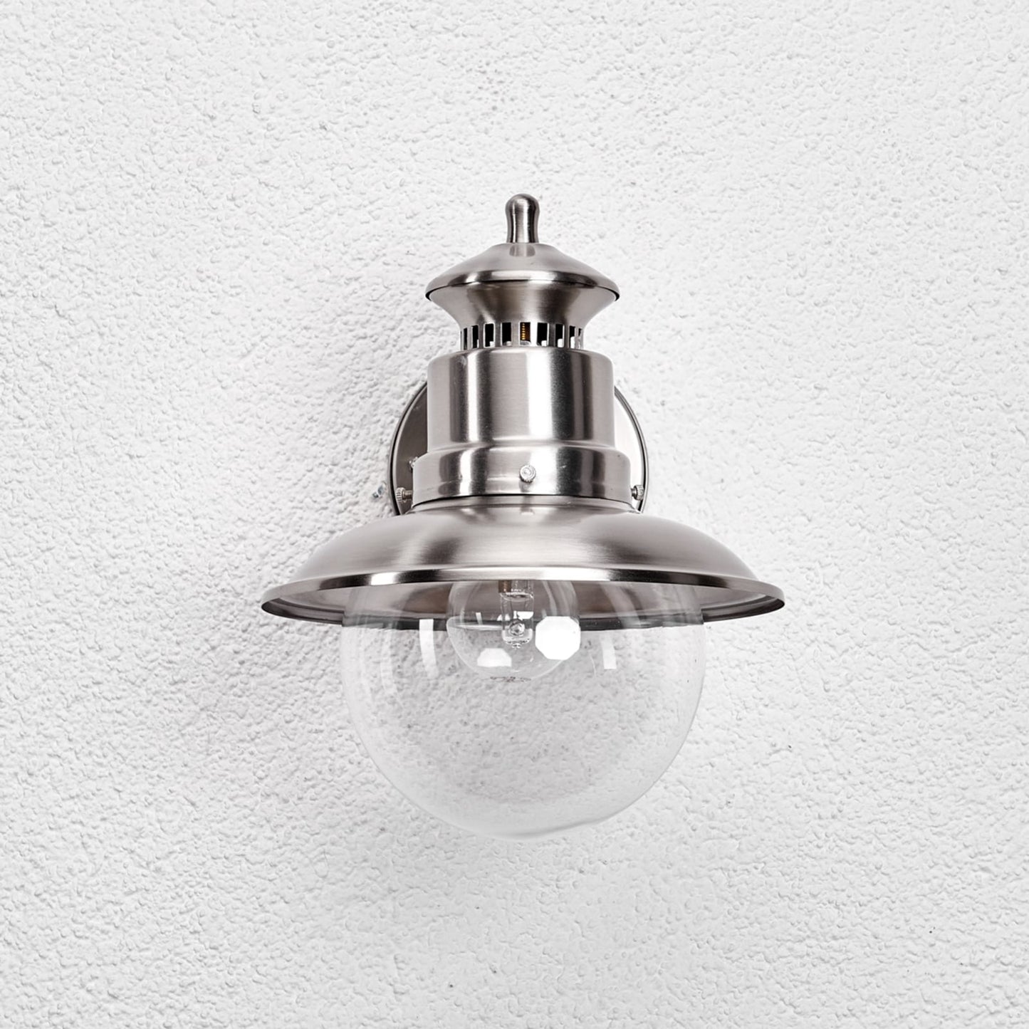 Front view of the Gwena stainless steel wall lantern showing the wide shade capping the round glass globe