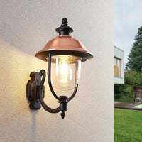 Koma copper outdoor lantern mounted beside a garden with lawn and modern house behind