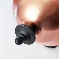 Close detail of the brushed copper dome and black finial on the Koma lantern