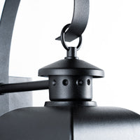 Close view of the Merto lantern finial, ring and curved black scroll arm