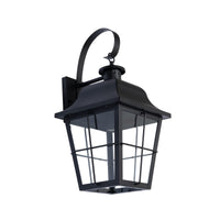 Merto caged lantern outdoor wall light in black iron with clear glass panes on a plain white background