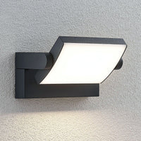 Shiro outdoor wall light mounted on a rendered wall with the head angled downwards