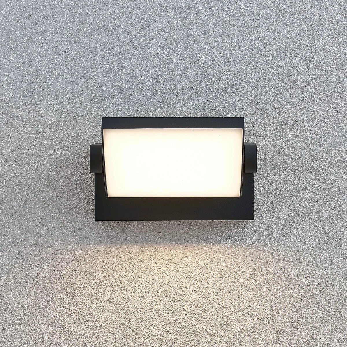 Shiro wall light lit at night showing the wide warm white light panel