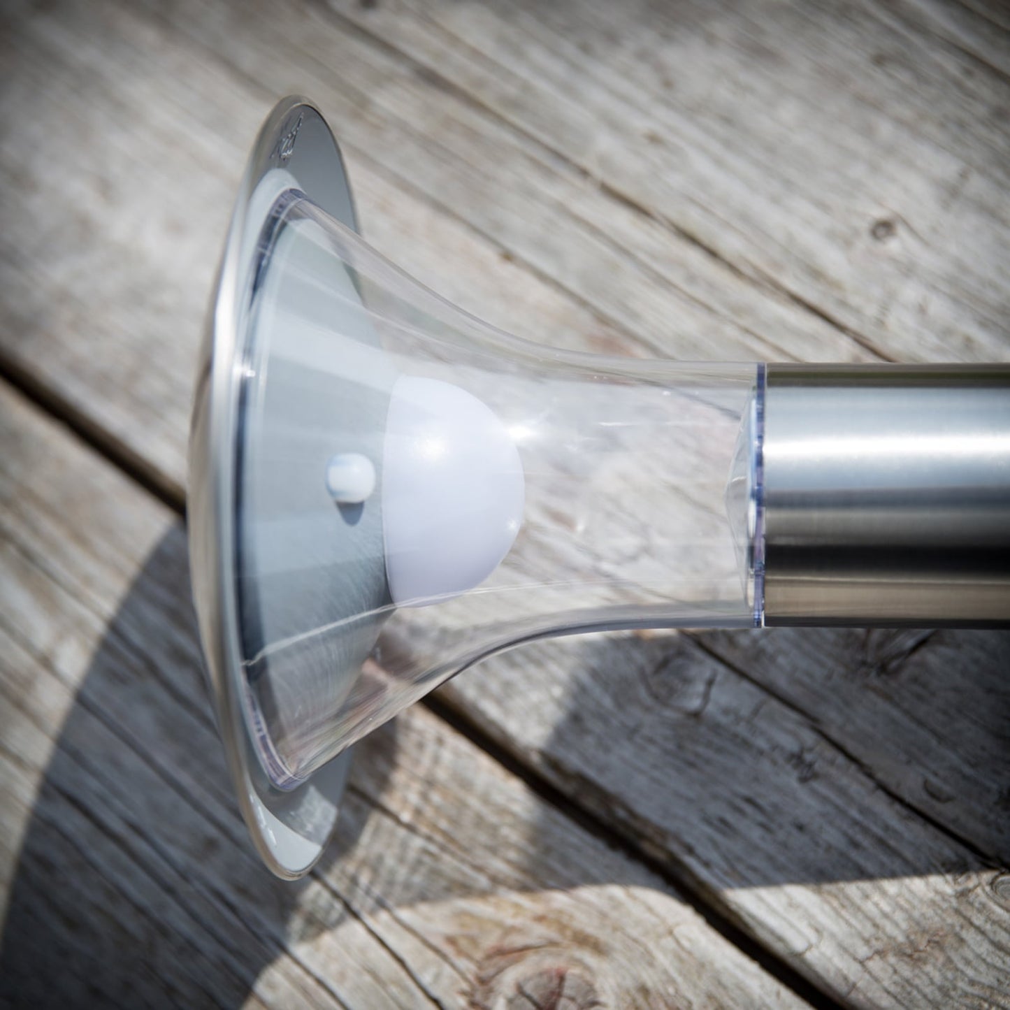 Detail of the Jolo solar spike light showing the integrated LED under the clear flared diffuser