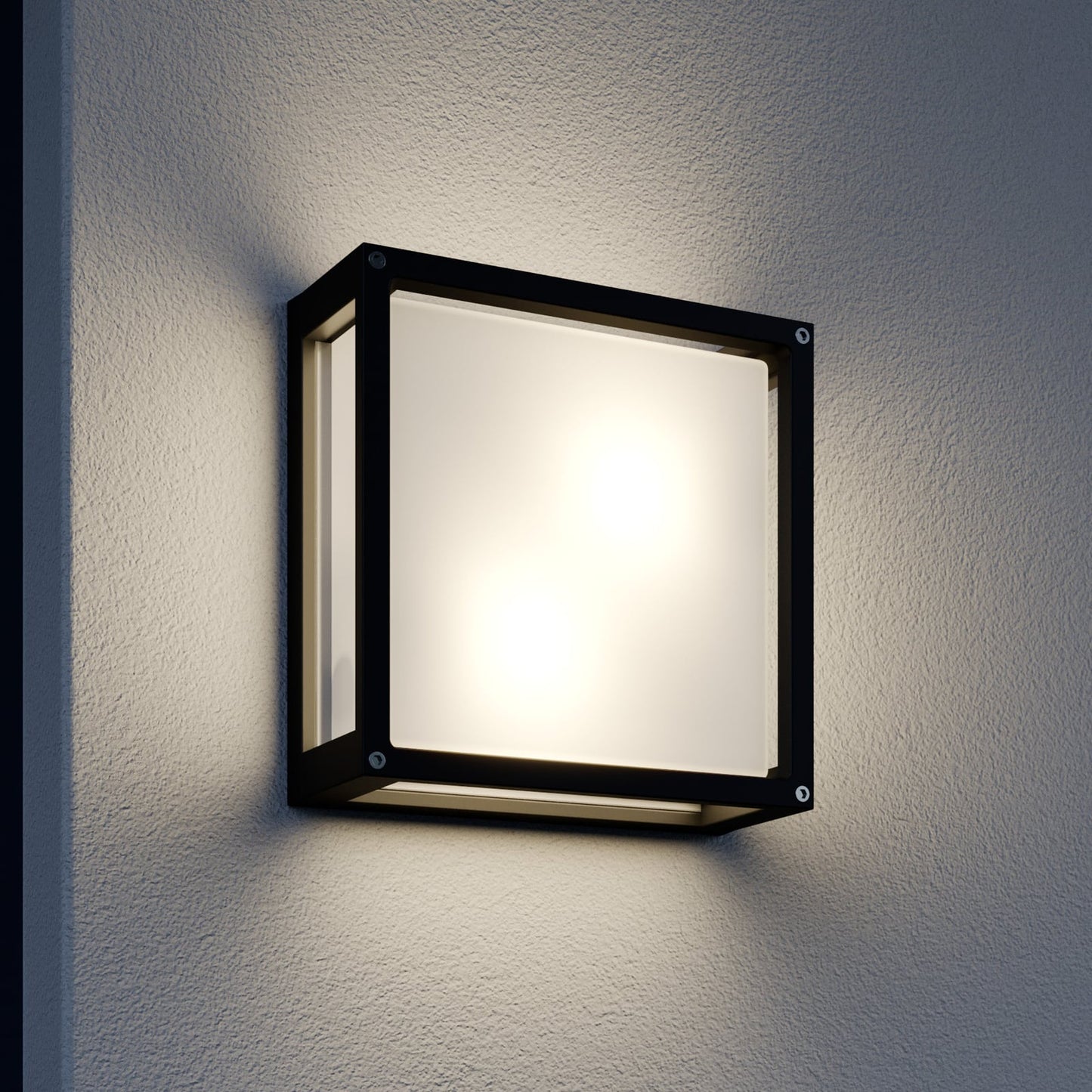 Auri square outdoor wall light switched on at night against a render wall, glowing evenly through the front and side glass panels