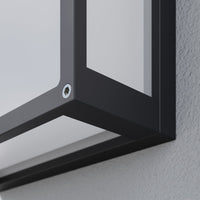 Close-up of a corner of the Auri square outdoor wall light showing the hex socket screw and the matte dark grey frame edge