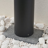 Base of the Darjo Tall Bollard Light set into a bed of white pebbles