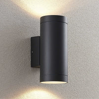 Tovi outdoor wall light mounted on a rendered wall casting light up and down