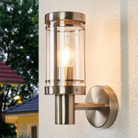 Davo outdoor wall light lit on a house wall at dusk
