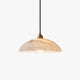 Delo alabaster dome pendant light with brass lampholder on a plain white background