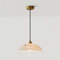 Full drop of the Delo pendant showing the brass ceiling canopy and black fabric cord