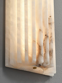 Close detail of the Alcaro alabaster wall light showing the natural stone veining and brass fixing