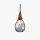Drova teardrop clear dimpled glass pendant light on a plain white background