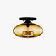 Valto Globe Ceiling Light with amber glass shade on a black flush mount