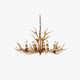 Stagra six-light antler resin candle chandelier in brown on a plain background
