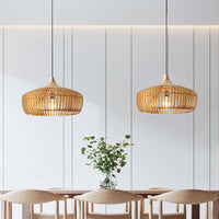 Two Muno natural wood pendant lights hanging over a dining table in a bright panelled room