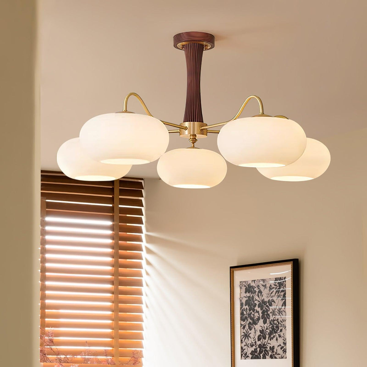 Sova chandelier close-up showing frosted glass shades and dark walnut column