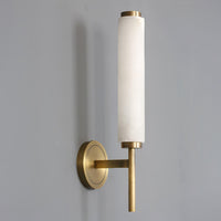 Angled view of the Jerno brass and alabaster sconce mounted on a grey wall
