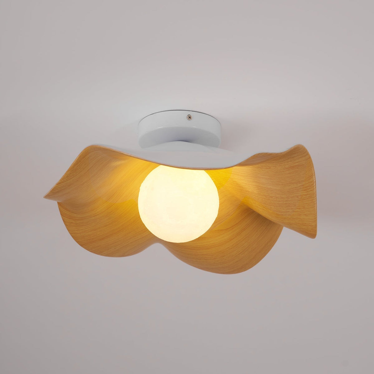 Tamsi wood-grain ceiling light lit, showing the opal globe bulb inside the petal shade