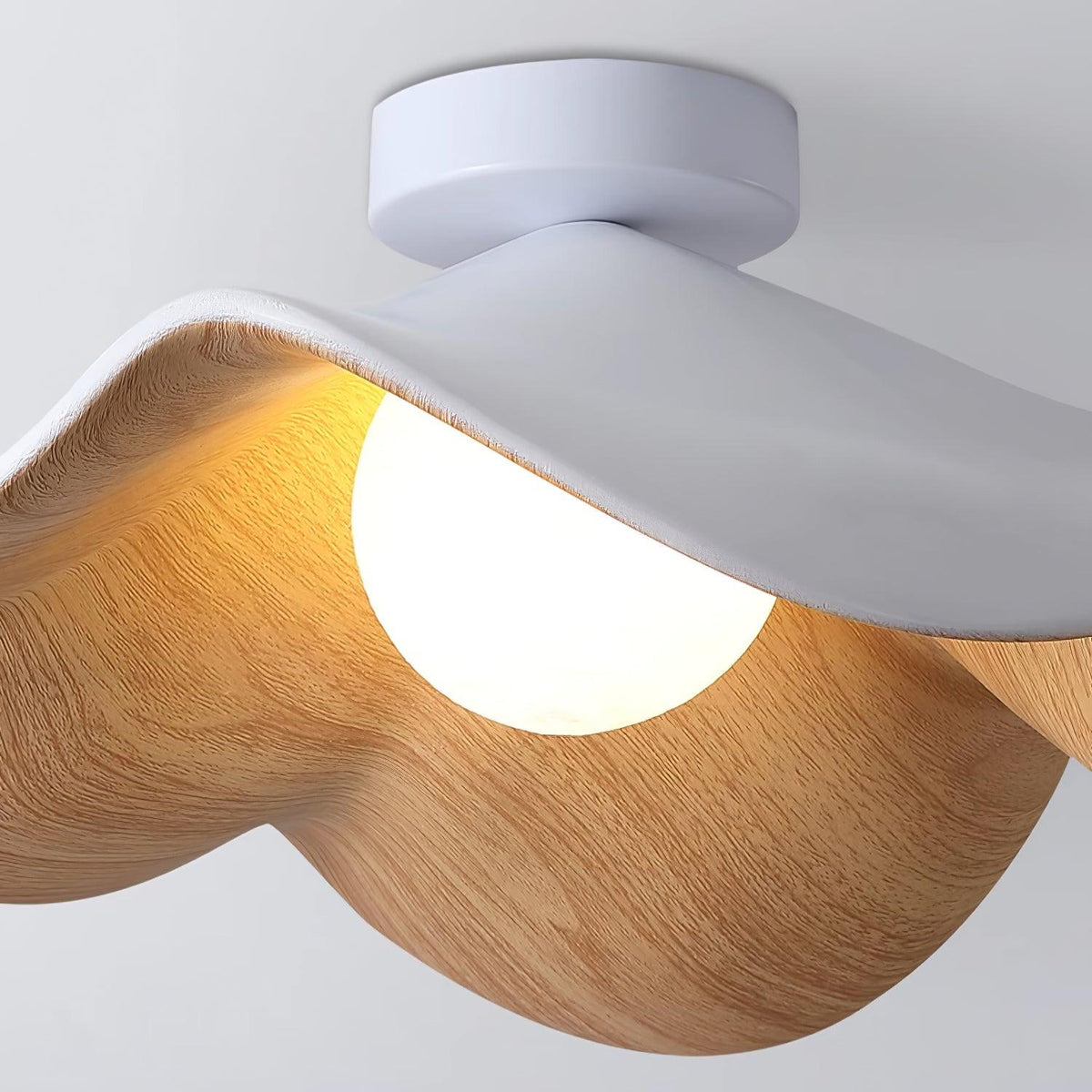 Close view of the Tamsi ceiling light showing the wood-grain texture on the underside of the petals