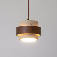 Close view of the Cavora travertine shade and walnut band with the diffuser lit