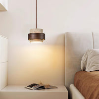 Petra travertine pendant light used as a bedside light above a cream bedside table