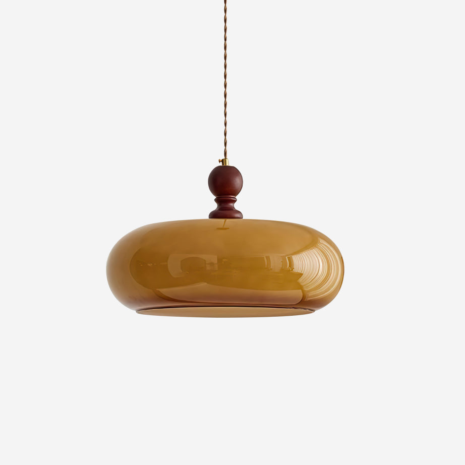 Halvo amber glass pendant light with walnut finish wood stem on a plain white background