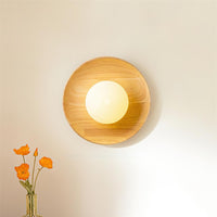 Grain of the pale wood disc around the opal glass globe of the Tamso wall light