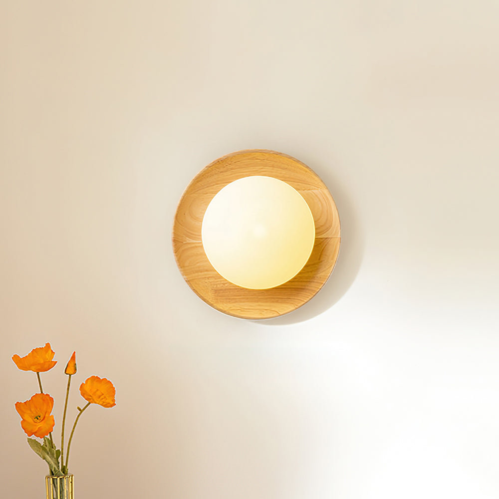 Tamso wall light mounted at bedside height casting a soft pool of warm light