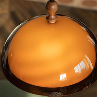 Close view of the Pomera dome showing the walnut finial and the darker brown rim of the shade