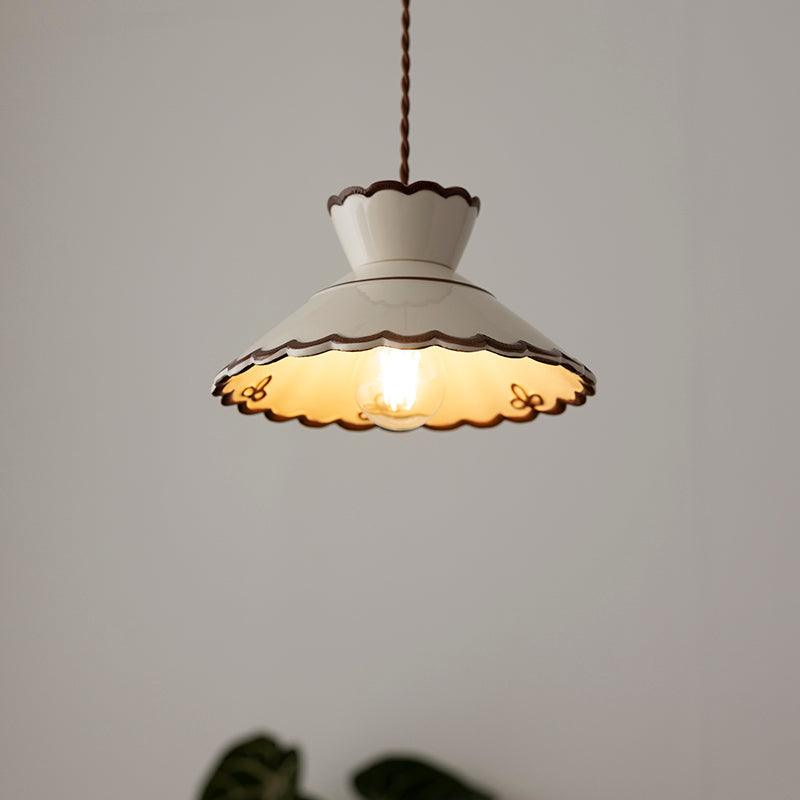 Wenna cream ceramic pendant light hanging above a dining area