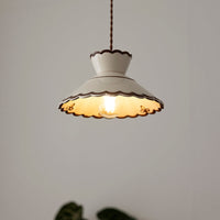 Wenna cream ceramic pendant light hanging above a dining area