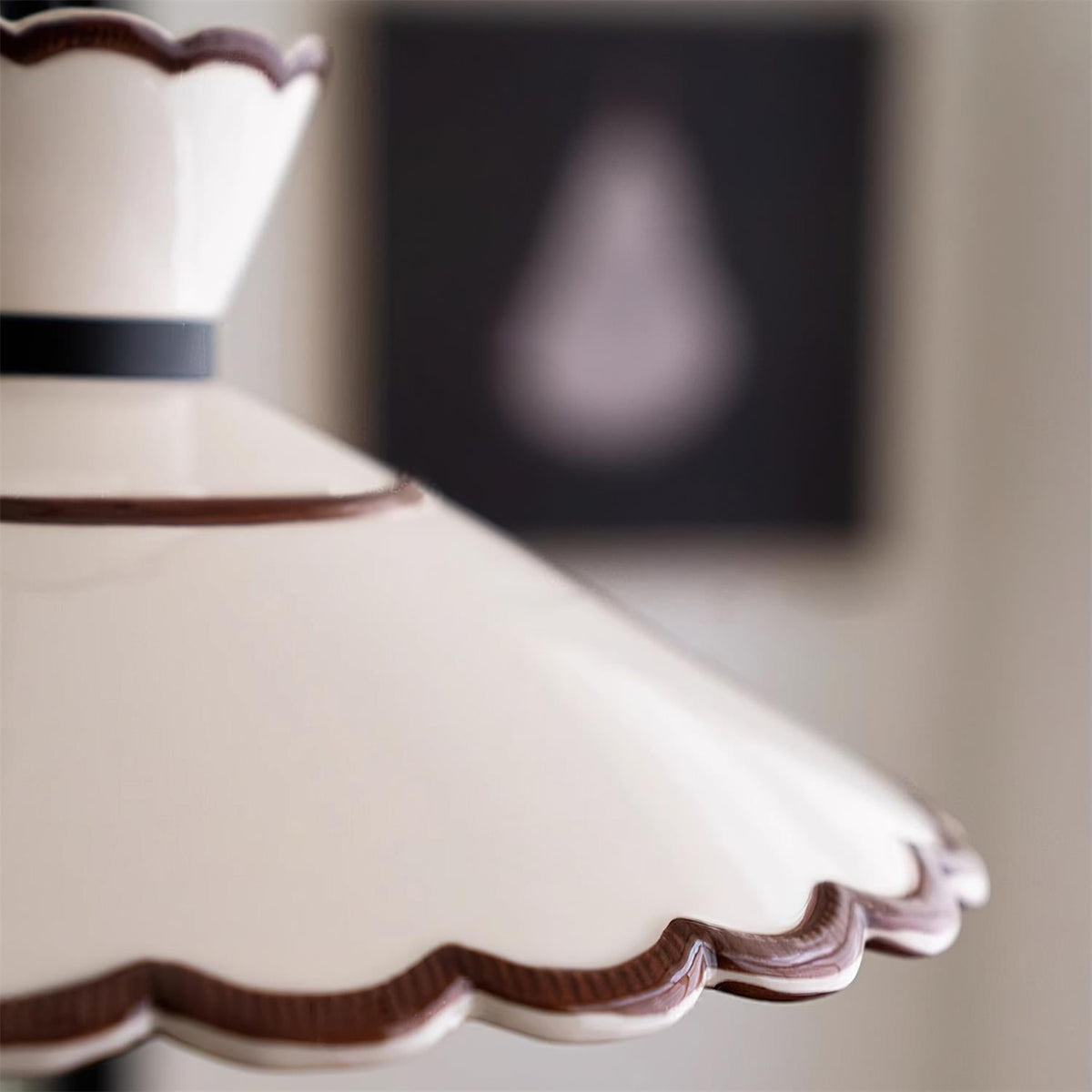 Close-up of the Wenna glazed ceramic shade edge and fluted scallop detail