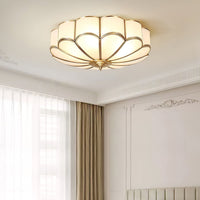 Ulina ceiling light lit in a living room with tall curtains and cornice detailing