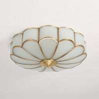 Ulina flush mount ceiling light fitted to a white ceiling in daylight, showing the brass finish frame