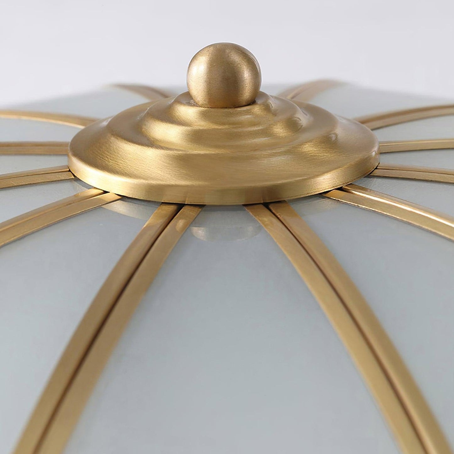 Detail of the brass finish centre boss and finial on the Ulina ceiling light
